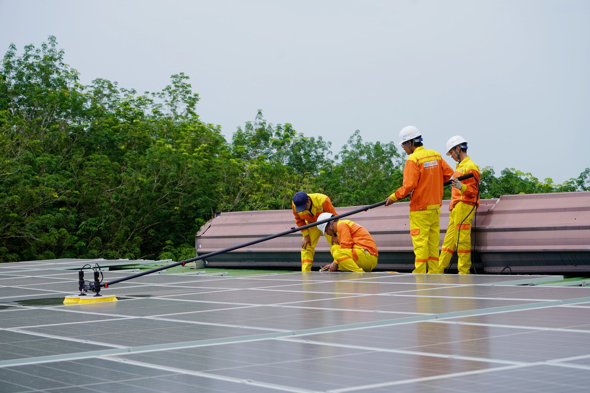 A group of men are working on a solar panel roof.